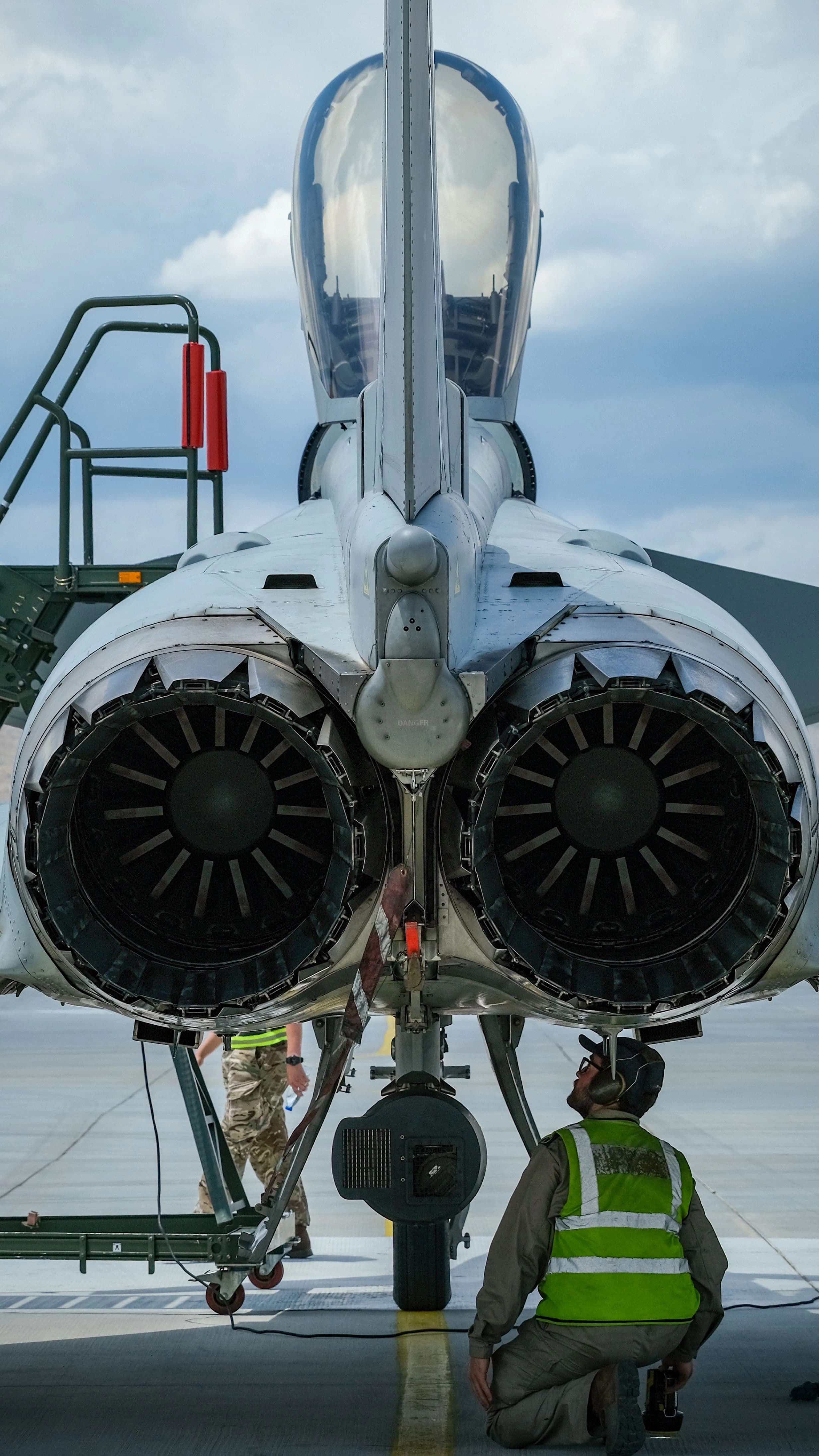 Aircraft mechanic performing maintenance on a plane inside a hangar