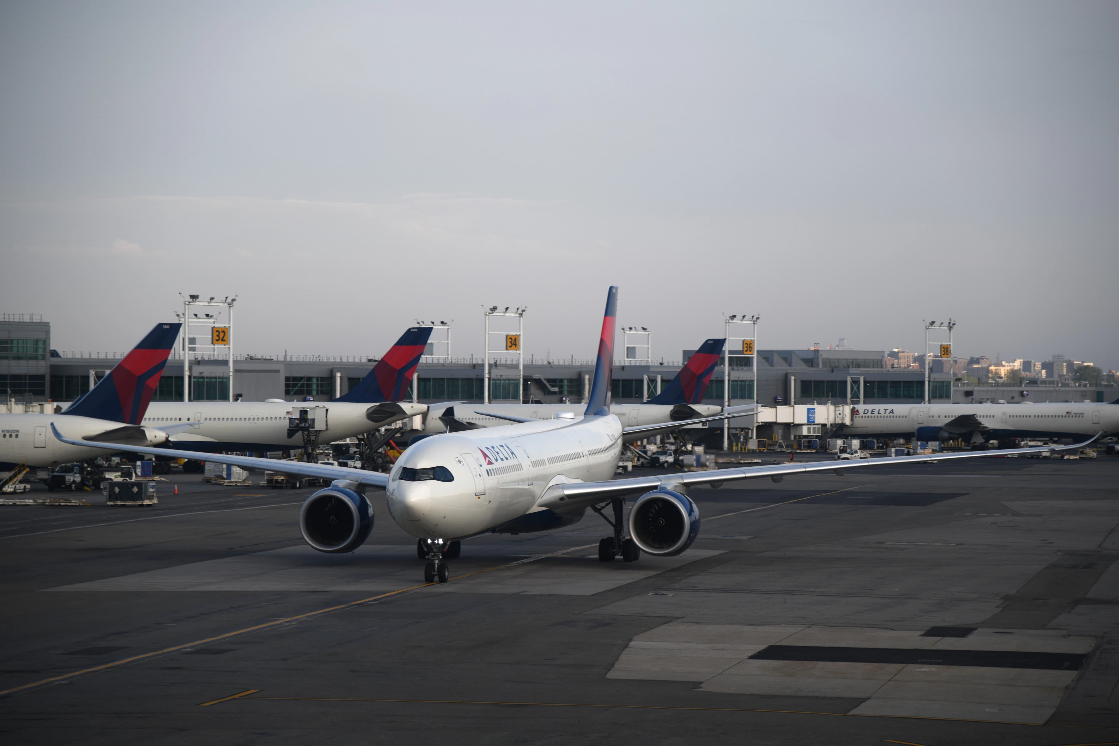 delta airlines on the runway at New York airport during the day
