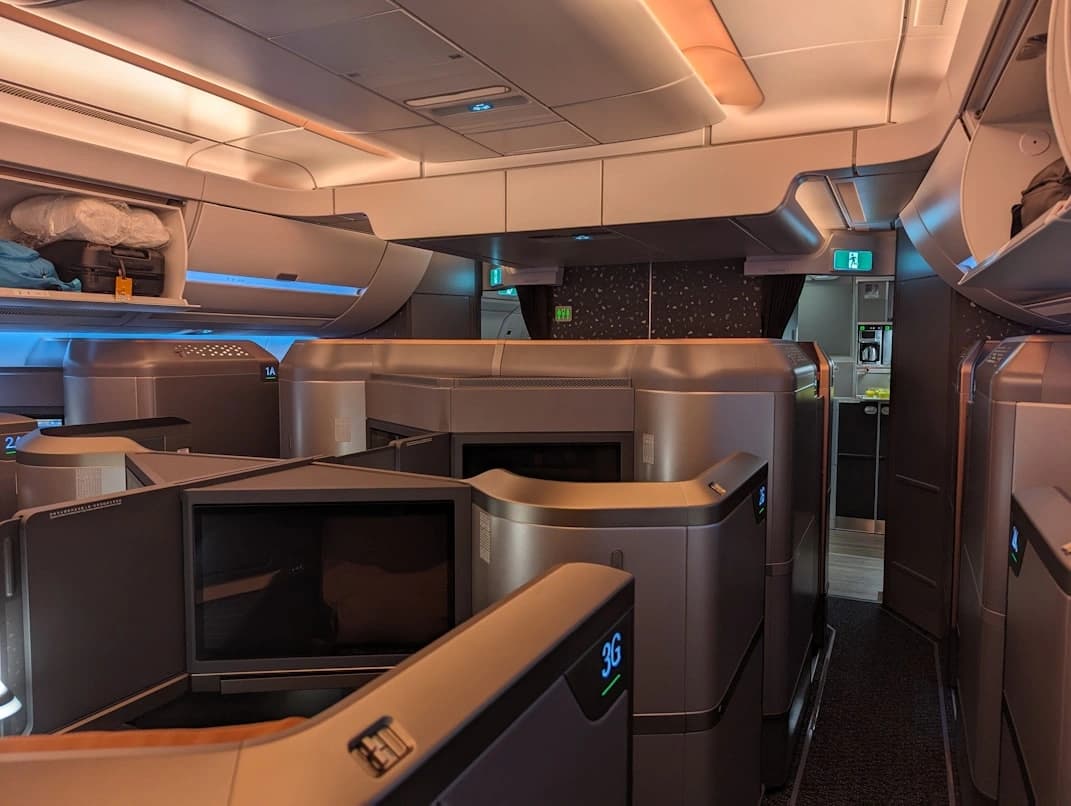 Lie-flat business class seat in a widebody aircraft cabin